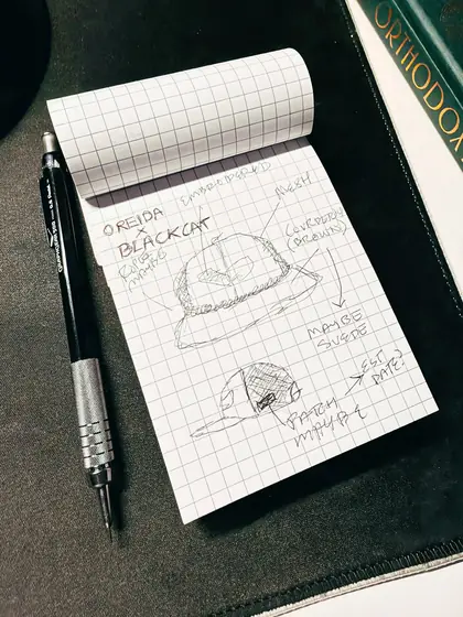 Graph-paper sketch specifying the cap's corduroy, crown and brim