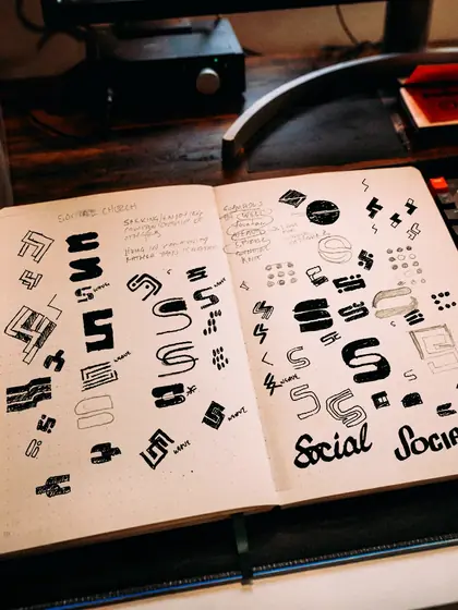 Sketchbook pages of early Social Church monogram explorations